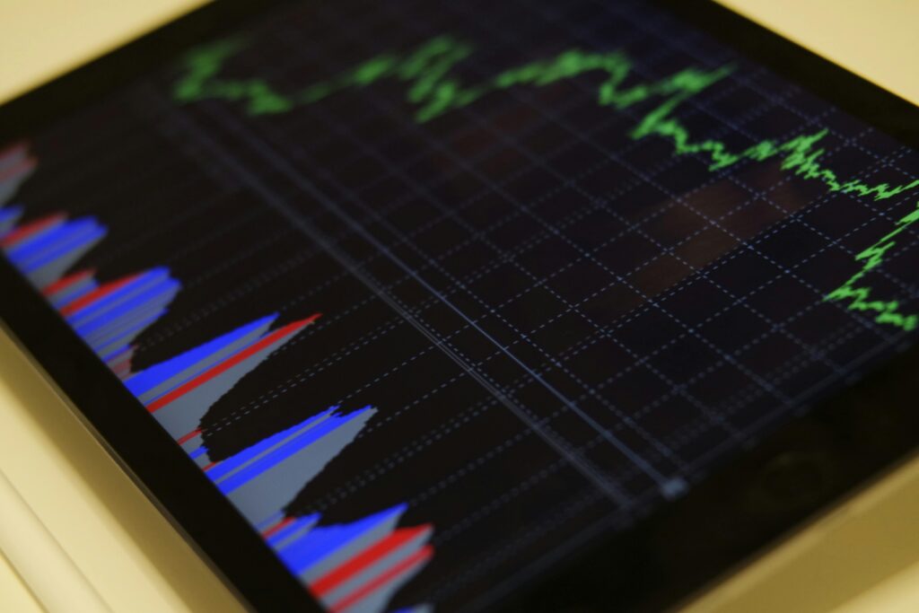 pexels-photo-186461-186461 Close-up of a tablet displaying stock market analysis with colorful graphs.